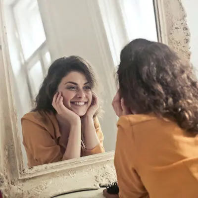 woman looking to mirror